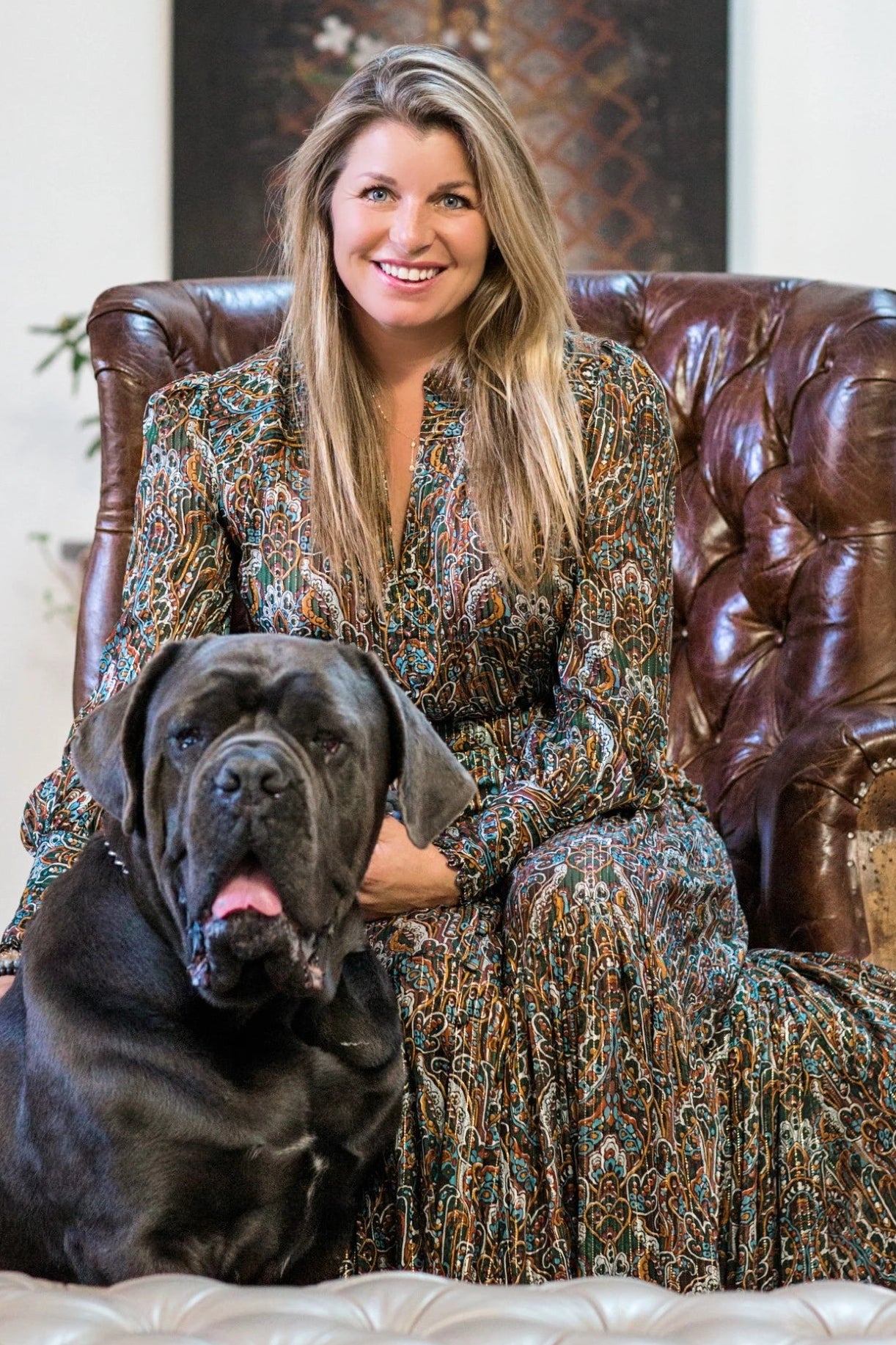 michelle griffin sitting in a leather chair with her dog